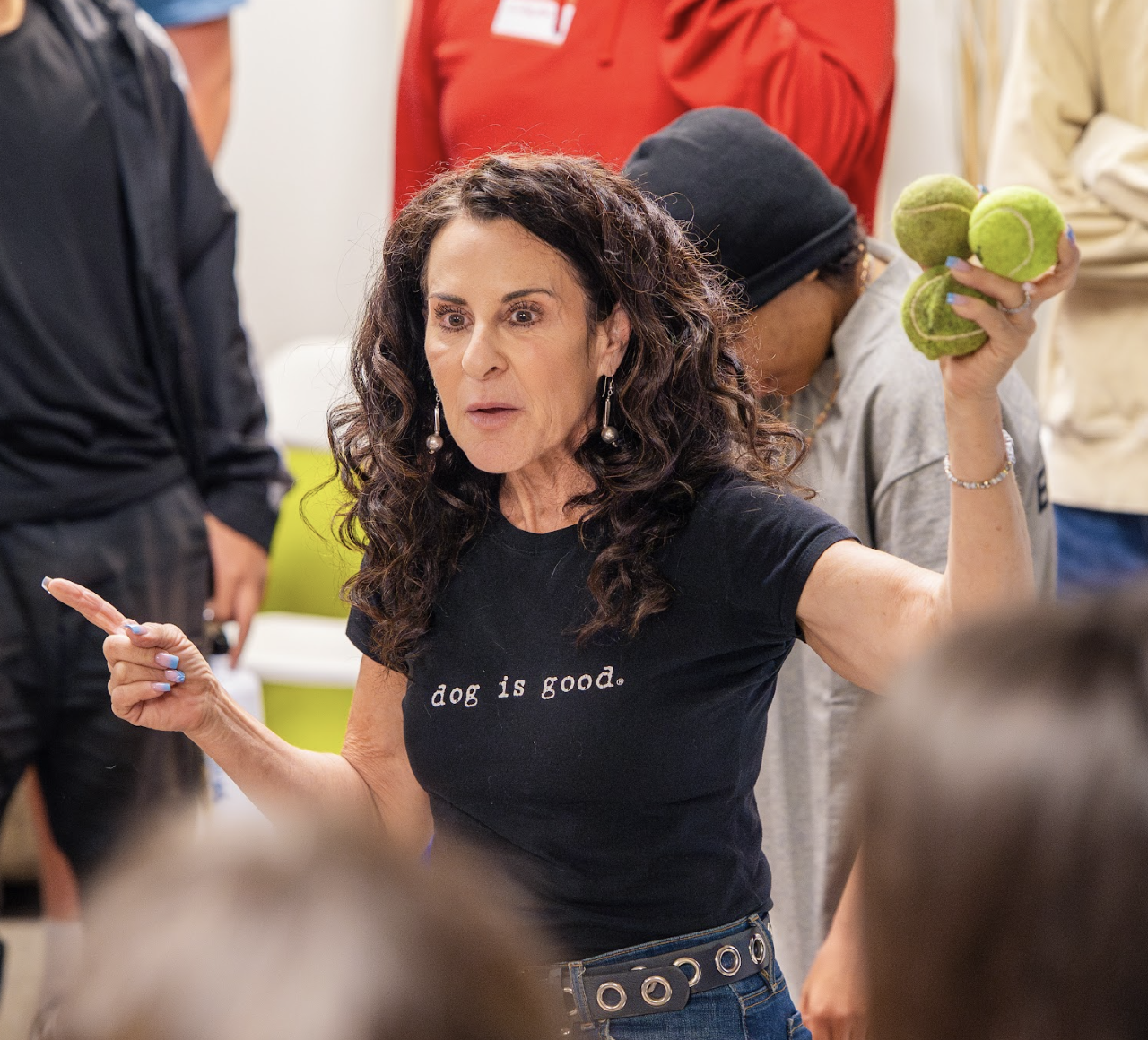 Gila Kurtz speaking at a BOLO Project workshop, holding tennis balls